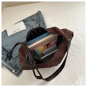 Interior view of brown suede tote bag showing spacious storage for books and phone