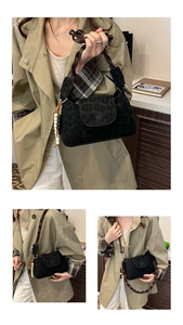 Detail of black leopard print crossbody bag with woven handle and beaded charm