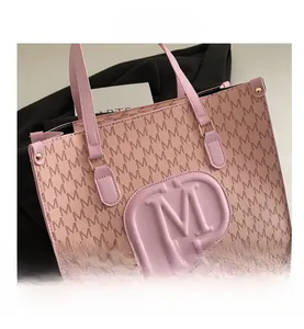 Detail view of pink tote bag with M-letter monogram print and embossed front logo