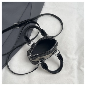 Top view of mini crossbody bag showing silver zipper and gray textured fabric detail