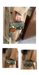 Detail of dark green Boston bag with metal studs and ethnic style wide shoulder strap