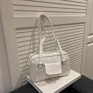 Minimalist white high-gloss large shoulder bag for women on book with blinds background
