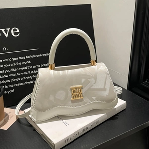 Elegant white textured leather handbag with wavy base and gold logo for 2025 fashion style