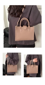 Detail view of taupe tote bag showing structured design and golden metal hardware