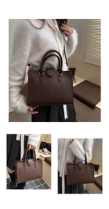 Detail of dark brown lychee leather handbag with golden hardware and adjustable strap