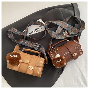 Detail of vintage small crossbody bags with gold rivets and ethnic print wide straps
