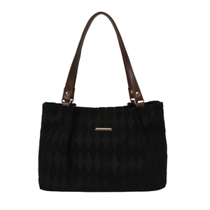Minimalist black quilted tote bag with brown leather handles and golden hardware