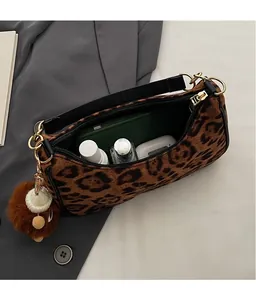 Detail view of leopard print plush bag interior showing spacious storage for essentials