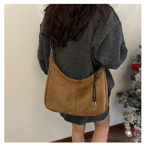 Brown frosted leather hobo bag side detail shown on model with cozy winter vibe