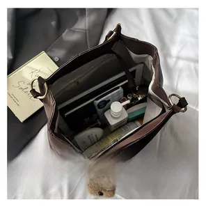 Top view of brown tote bag showing spacious interior with iPad and daily essentials