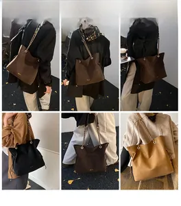 Detail view of large bucket bag with chain strap in dark coffee, black and khaki colors