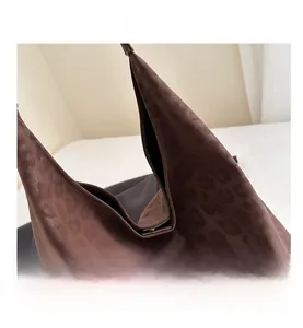 Detailed macro view of leopard print suede tote bag showing opening and inner construction