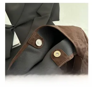 Detail of silver magnetic snaps on brown leopard print tote bag with soft faux suede