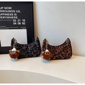 Detailed view of leopard print hobo bags with zipper, chain handles, and plush charms