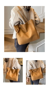 Detail view of camel leather tote bag with chain strap and side drawstring accents
