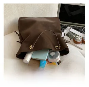 Internal view of brown suede tote bag showing large capacity for laptop and cosmetics