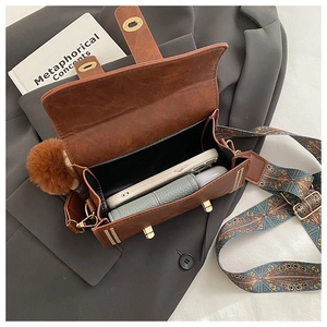 Internal view of brown vintage Boston bag with ethnic strap and plush charm detail