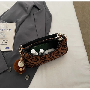 Detail of leopard print handbag interior capacity with phone and accessories