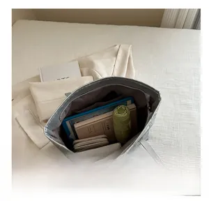 Interior view of spacious silver tote bag showing tablet, umbrella, and daily essentials