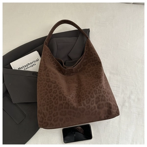 Detail of matte leopard print tote bag with soft suede texture for professional look