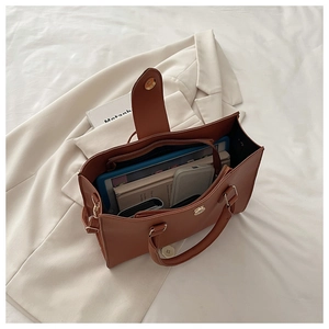 Interior detail of large brown leather tote bag showing spacious compartments and items