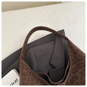 Detailed view of brown leopard print hobo bag texture and soft suede-like finish