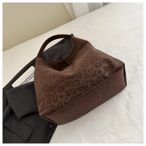 Close-up of leopard print tote bag with soft suede texture and stylish brown animal pattern