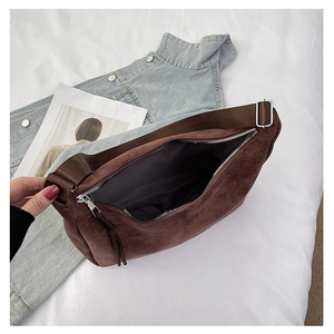 Top view of open dark brown suede tote bag with silver zipper and adjustable wide strap