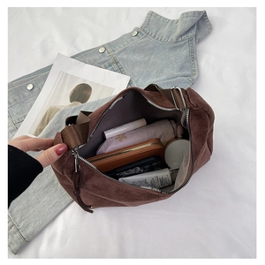 Top view of spacious brown corduroy tote interior holding umbrella, phone and wallet