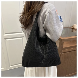 Detail of black leopard print tote bag in durable fabric with subtle textured pattern