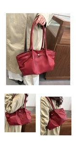Detail of dark red lychee grain leather tote bag with gold buckle and pleated texture