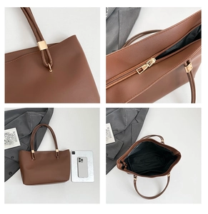 Detail view of brown tote bag with matte leather finish and secure golden metal zipper