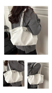 Detail of white large leather tote bag with lychee texture and gold buckle accents