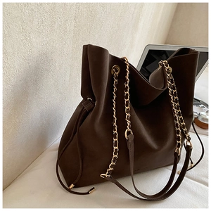 Deep brown suede bucket bag featuring large capacity and gold chain shoulder strap