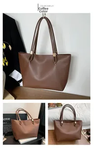 Detail view of coffee PU leather tote bag with long straps and gold-tone hardware