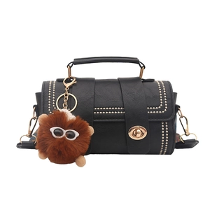 Retro black Boston cylinder bag with gold studs, lychee texture and monster charm
