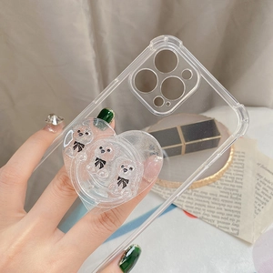 Close-up of clear iPhone case with heart-shaped resin grip featuring cute mini bears