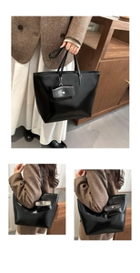 Detail view of black glossy tote bag set showing mirror finish and detachable small pouch