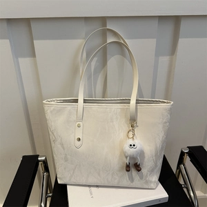 Chic white marble pattern tote bag for women featuring a cute plush doll keychain