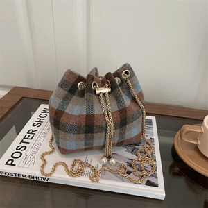 Winter plaid tweed bucket bag with golden chain strap and pearl drawstring detail