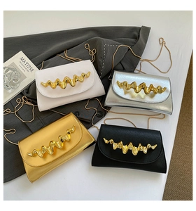Detail of four colorful leather chain purses with wavy gold handles and metallic straps
