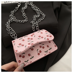 Detail of pink mini bag with cherry print and thick silver metal chain strap