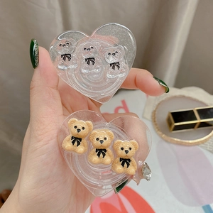 Close-up of glitter heart phone grip with cute bear figurines and bow details