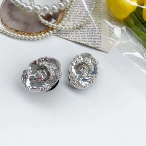 Close-up of vintage silver relief phone stands with elegant portrait engraving
