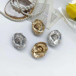 Close-up of vintage Baroque style portrait reliefs in gold and silver plating