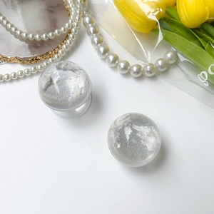 Detail of transparent planet cloud phone grip with white fog and silver glitter details
