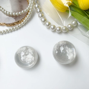 Macro view of clear resin phone socket featuring white cloud and silver glitter detail
