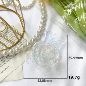 Detailed view of bear-shaped glitter phone grip with heart sequins and size specifications