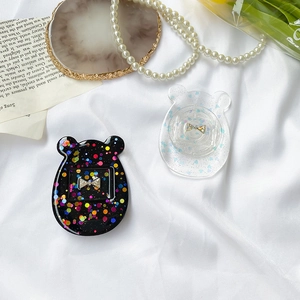 Detail of glitter resin phone grips with sequin bear heads and bow accents