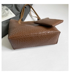 Close-up of deep brown woven leather texture on a large capacity tote bag